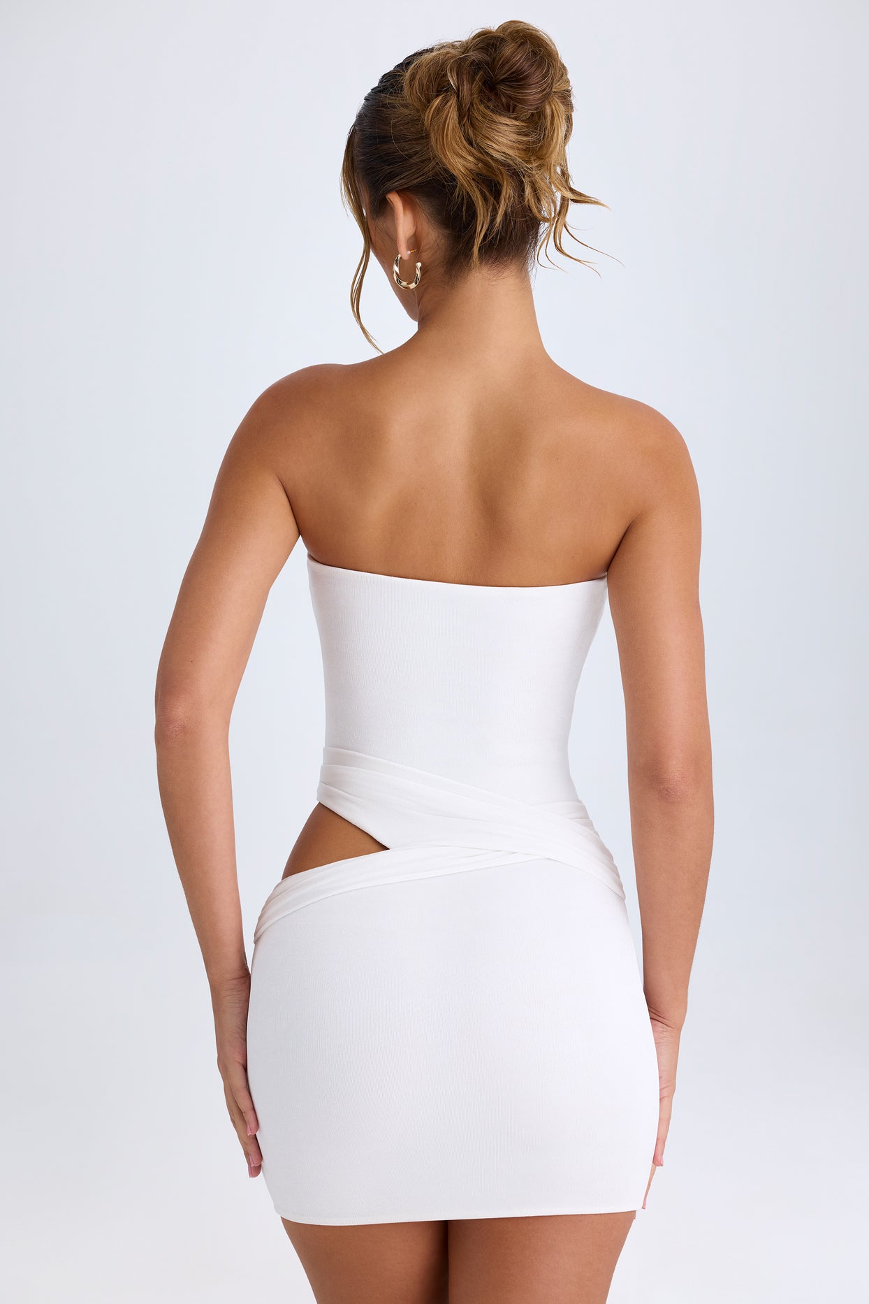 Mini-robe moulante bandeau découpée aux hanches en blanc