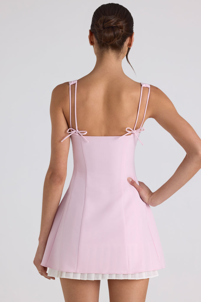 Mini-robe trapèze plissée avec nœud en rose tendre