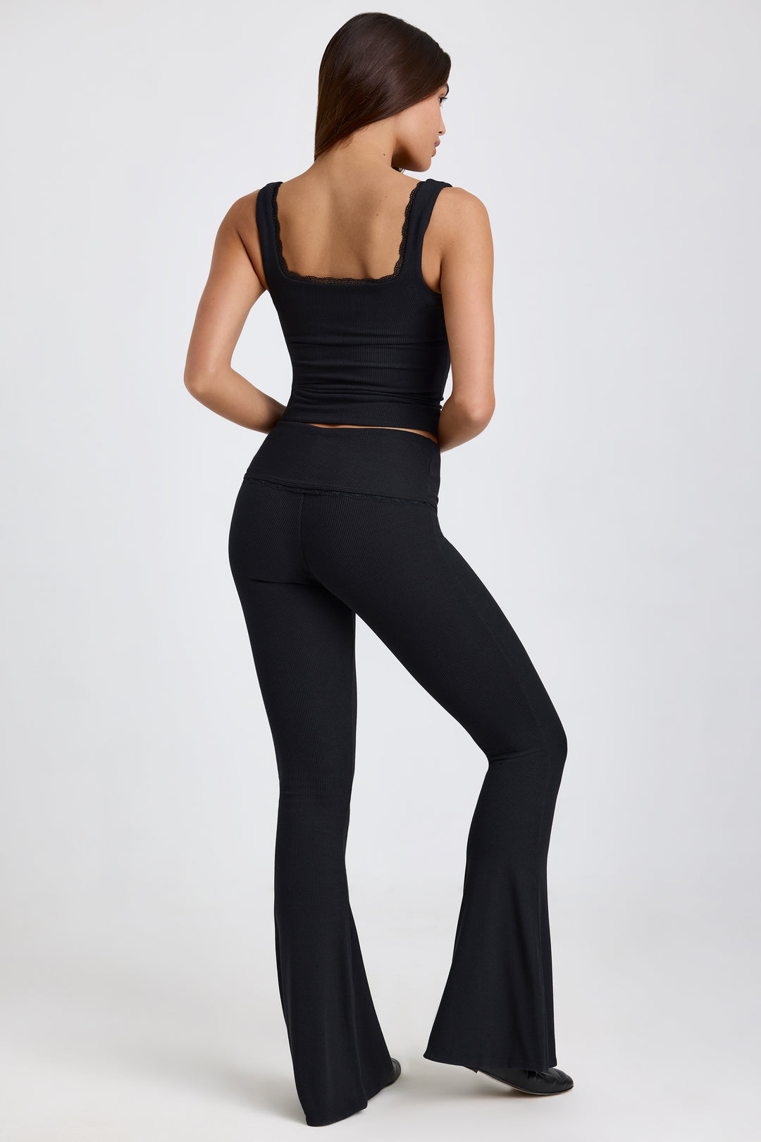 Jules Ribbed Modal Mid-Rise Foldover Flared Trousers in Black | Oh Polly