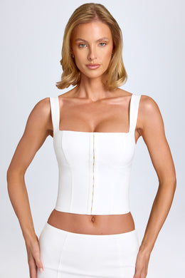 Haut corset à crochets et œillets en blanc