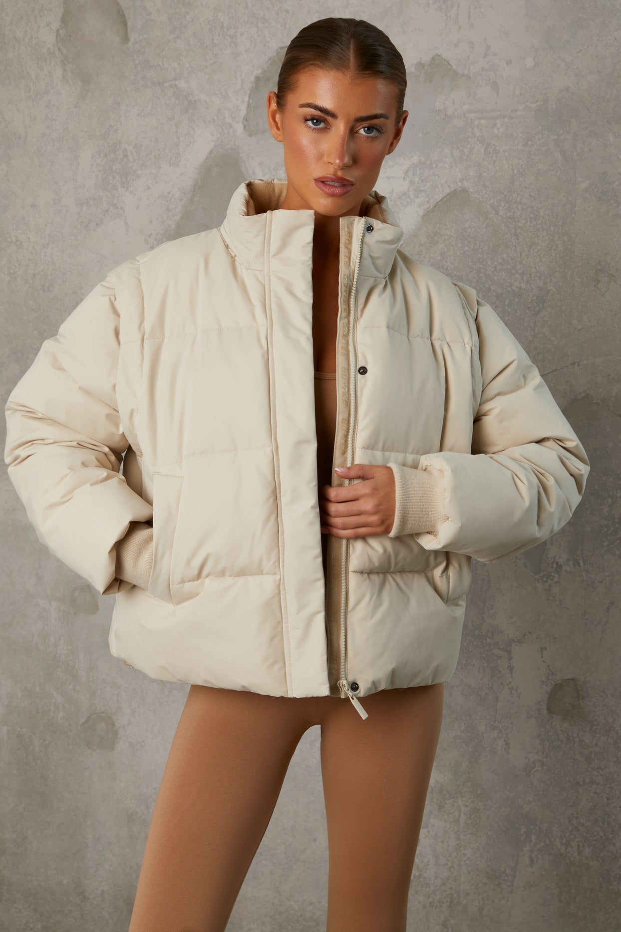 https://www.ohpolly.com/cdn/shop/files/BT0786_6_Sand-Cropped-Puffer-With-Removable-Sleeves.jpg?v=1695031311&width=1244