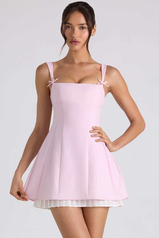 Mini-robe trapèze plissée avec nœud en rose tendre